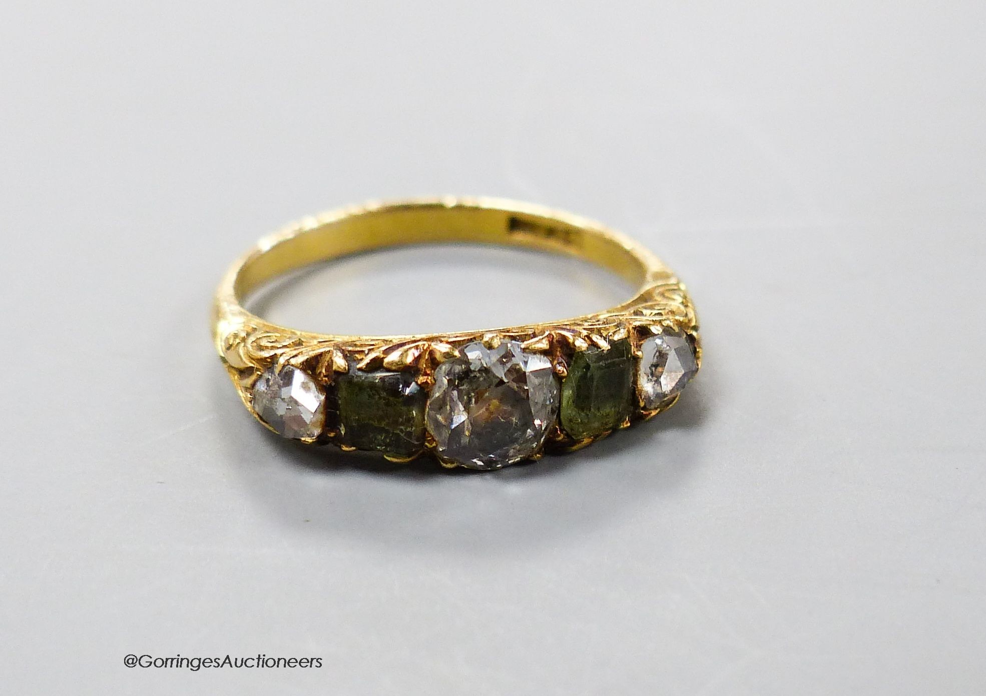 An early 20th century 18ct, three stone rose cut diamond and two stone olivine? set half hoop ring, size N/O, gross 3.5 grams.